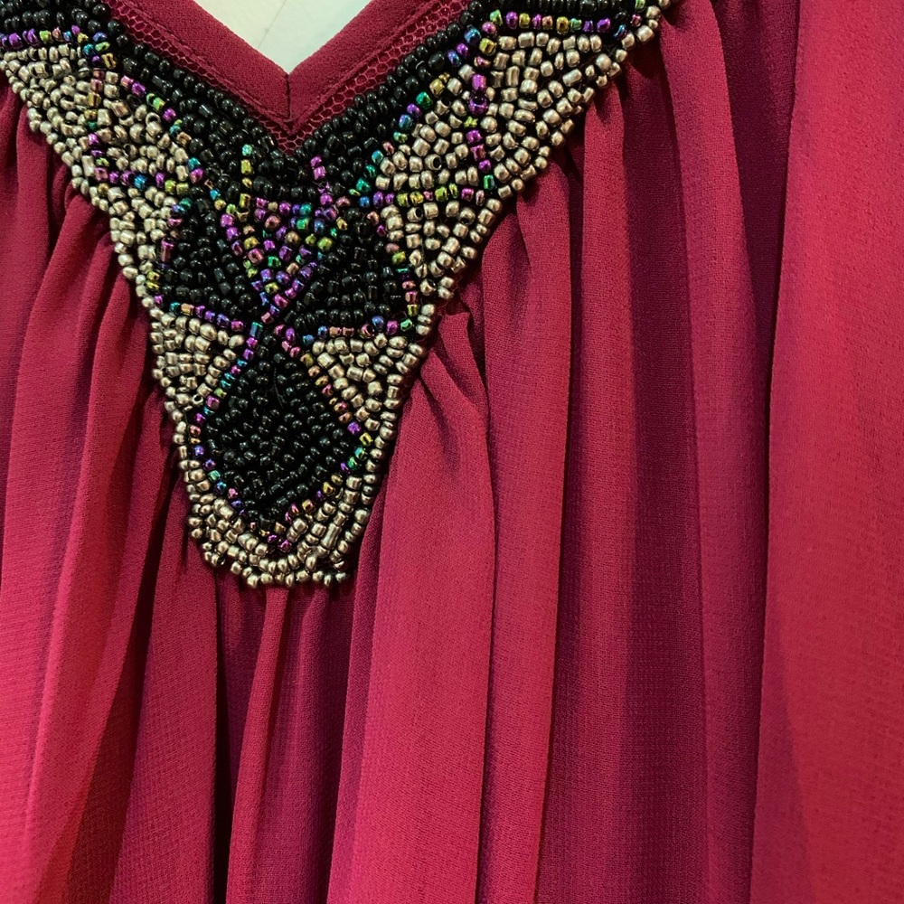 Cute and flirty dress with bold jewel detailing.
